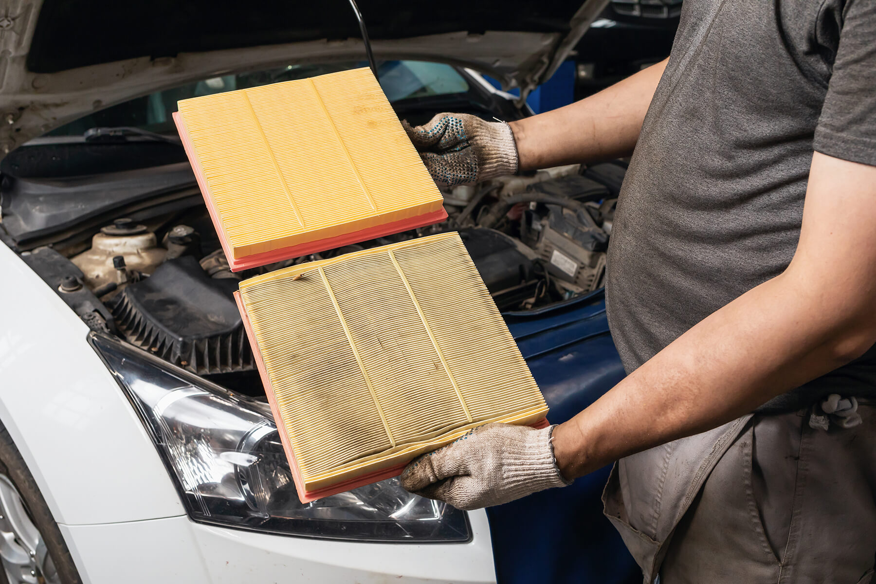 auto-mechanic-shows-old-new-engine-air-filter-passenger-car_sml